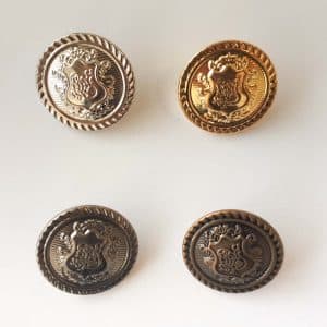 Metal buttons with a shield design in four colours
