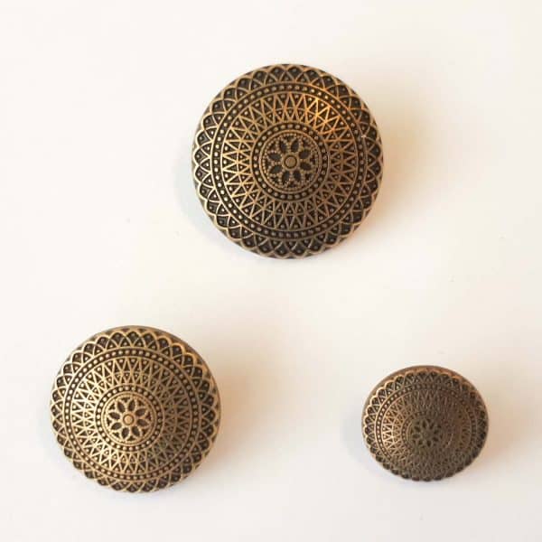Metal buttons with starburst design in three sizes