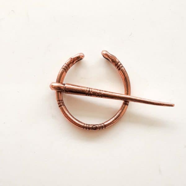 Tiny fibula in an aged copper colour