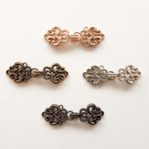 Tiny cloak clasp in four colours