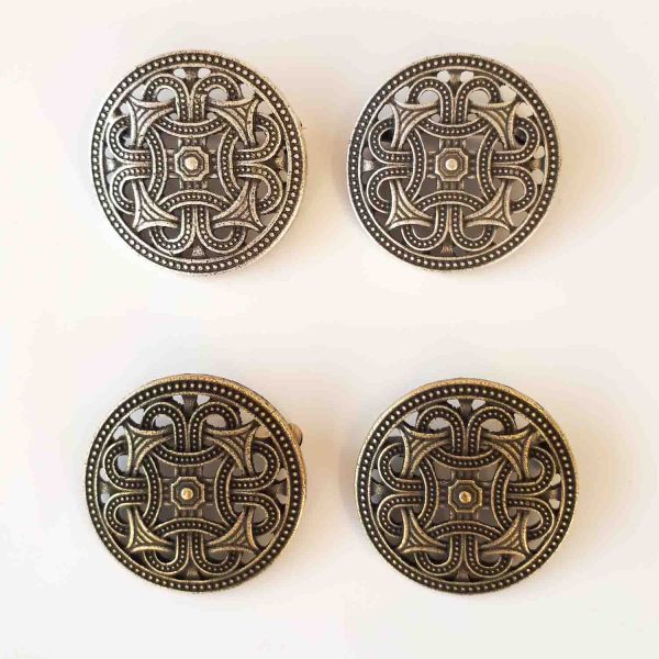 Round viking brooches with an arrow design.